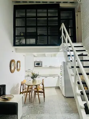a kitchen with a staircase and a table with chairs at La Botica Grupo AC Gestion in Cádiz