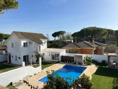 a villa with a swimming pool and a house at Villa en Urbanización Ciudad Ducal in El Puerto de Santa María