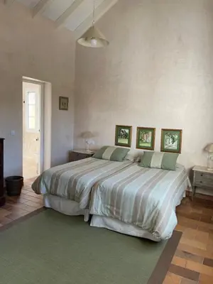 a bedroom with a large bed with three pictures on the wall at Villa en Urbanización Ciudad Ducal in El Puerto de Santa María