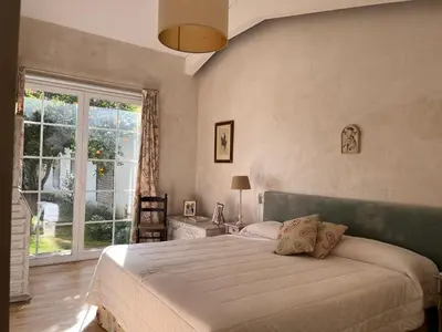 a bedroom with a large bed and a window at Villa en Urbanización Ciudad Ducal in El Puerto de Santa María