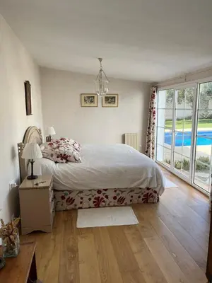 a bedroom with a bed and a large window at Villa en Urbanización Ciudad Ducal in El Puerto de Santa María