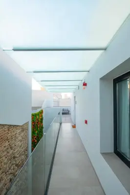 a corridor in a building with a plant on the wall at VILLAR Suites by Cadiz4Rentals in Cádiz