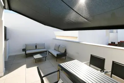 a room with chairs and a table and a window at VILLAR Suites by Cadiz4Rentals in Cádiz