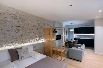 a bedroom with a bed and a living room at VILLAR Suites by Cadiz4Rentals in Cádiz