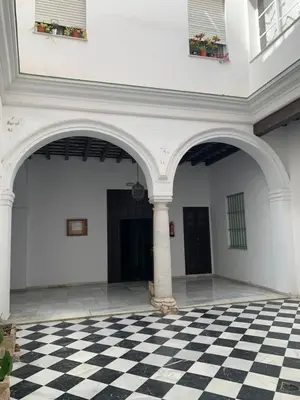 an empty room with a checkered floor in a building at Casa Murillo in El Puerto de Santa María