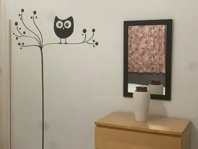 a wall with a black owl on a tree branch decal at Casa Murillo in El Puerto de Santa María