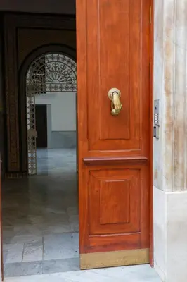 a wooden door with a gold knocker on it at Casa Manuel de Falla by Cadiz4Rentals in Cádiz