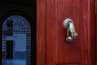 a wooden door with a brass door knocker on it at Casa Manuel de Falla by Cadiz4Rentals in Cádiz