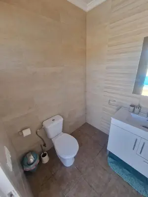 a bathroom with a white toilet and a sink at Las Vistas in Arcos de la Frontera