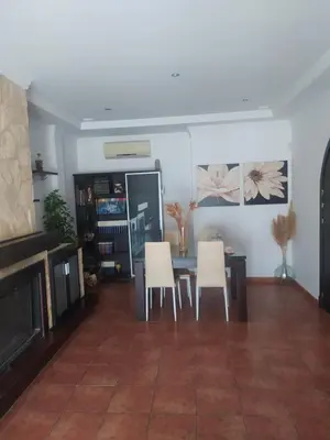 a dining room with a table and white chairs at Las Vistas in Arcos de la Frontera