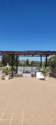 a pavilion with potted plants on a patio at Las Vistas in Arcos de la Frontera