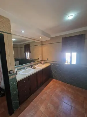 a bathroom with a sink and a large mirror at Las Vistas in Arcos de la Frontera