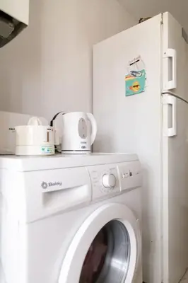a white washer and dryer in a room at Al lado de la victoria in Cádiz