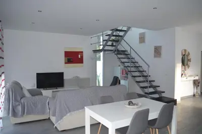 a living room with a couch and a staircase at Villa Cristal in Chiclana de la Frontera