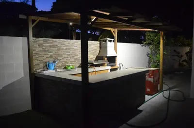 a outdoor kitchen with a counter with a stove at Villa Cristal in Chiclana de la Frontera