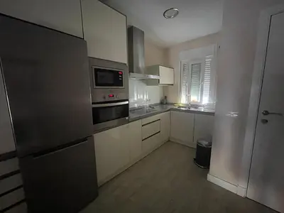 a kitchen with a refrigerator and a microwave at Apartamento de Reme Playa de la Barrosa in Chiclana de la Frontera