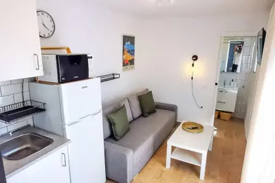 a small living room with a couch and a table at Apartamento Mery Oliva in Chiclana de la Frontera