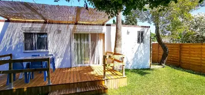 a house with a wooden deck and a fence at Apartamento Mery Oliva in Chiclana de la Frontera