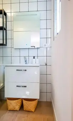 a white bathroom with a sink and a mirror at Apartamento Mery Oliva in Chiclana de la Frontera