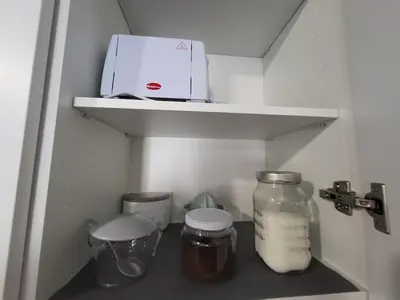 a shelf with a printer and jars in a refrigerator at Apartamento El Arrumbador in Jerez de la Frontera