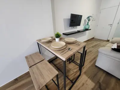 a dining room table with plates on it in a living room at Apartamento El Arrumbador in Jerez de la Frontera