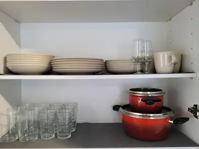 a kitchen shelf with plates and glasses on it at Apartamento La Albariza in Jerez de la Frontera