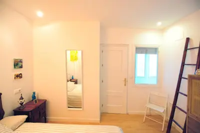 a bedroom with a bed and a mirror at Atico Brisa in Cádiz