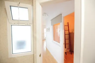 a room with a hallway with a window and a ladder at Atico Brisa in Cádiz