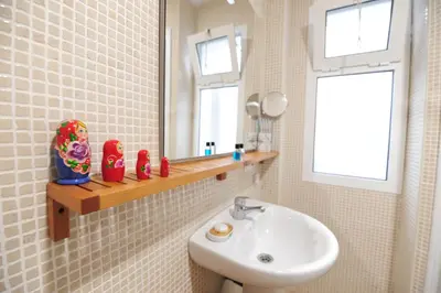 a bathroom with a sink and a mirror at Atico Brisa in Cádiz