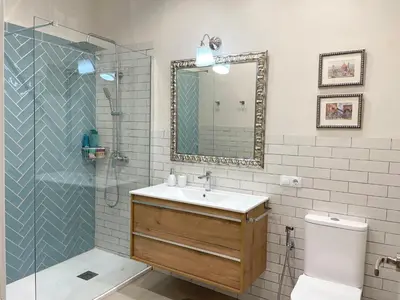 a bathroom with a sink and a shower with a mirror at Casa Sanlucar Centro in Sanlúcar de Barrameda