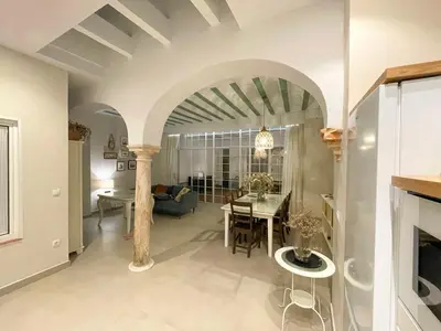 a living room with a table and a dining room at Casa Sanlucar Centro in Sanlúcar de Barrameda