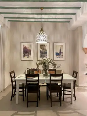 a dining room with a white table and chairs at Casa Sanlucar Centro in Sanlúcar de Barrameda