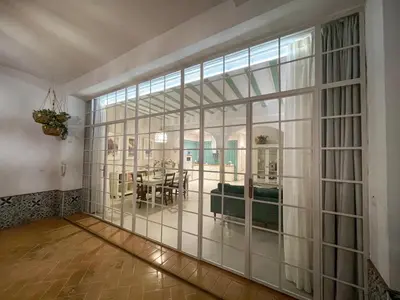 a large room with a large glass wall at Casa Sanlucar Centro in Sanlúcar de Barrameda