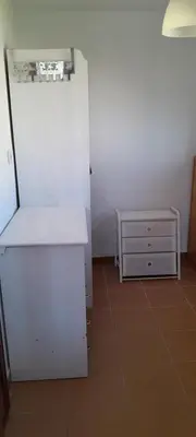 a kitchen with a white refrigerator and a dresser at PINZAPO in El Puerto de Santa María