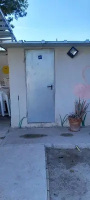 a white building with a door on the side of it at PINZAPO in El Puerto de Santa María
