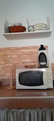 a microwave sitting on top of a counter at PINZAPO in El Puerto de Santa María
