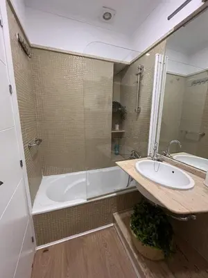 a bathroom with a shower and a sink and a tub at apartamentos Larios centro in Sanlúcar de Barrameda