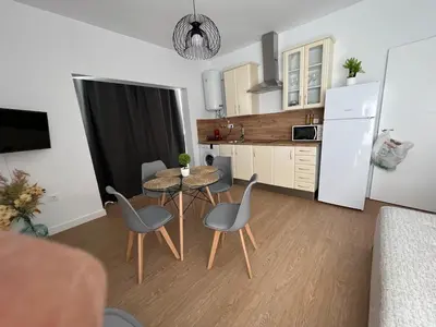 a kitchen and dining room with a table and chairs at apartamentos Larios centro in Sanlúcar de Barrameda