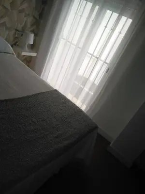 a bedroom with a bed and a window at apartamentos Larios centro in Sanlúcar de Barrameda