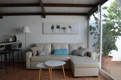 a living room with a couch and a table at Alojamiento entero Valdelagrana in El Puerto de Santa María