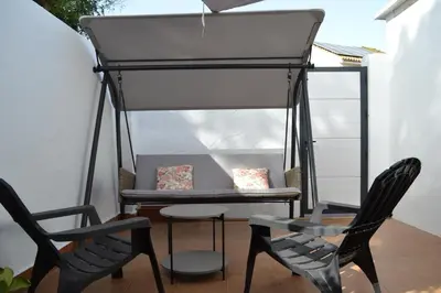 a porch with two chairs and a table and two chairs at Alojamiento entero Valdelagrana in El Puerto de Santa María