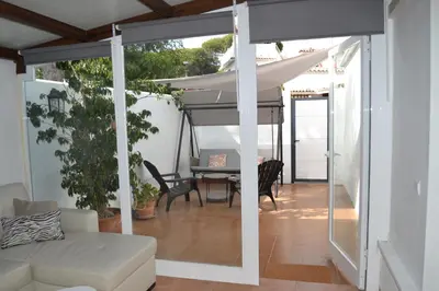 a living room with a couch and an umbrella at Alojamiento entero Valdelagrana in El Puerto de Santa María