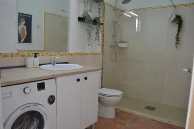 a bathroom with a toilet a sink and a shower at Alojamiento entero Valdelagrana in El Puerto de Santa María