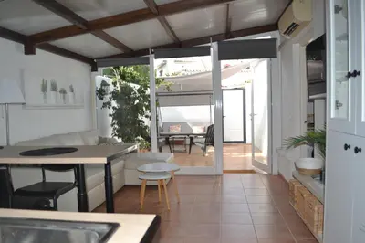 a kitchen and living room with a table and chairs at Alojamiento entero Valdelagrana in El Puerto de Santa María