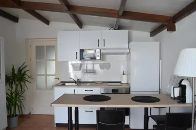a kitchen with white cabinets and a counter top at Alojamiento entero Valdelagrana in El Puerto de Santa María