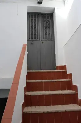 a set of stairs leading to a door on a building at Alojamiento Teja in Arcos de la Frontera