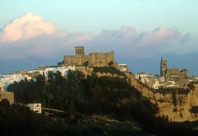 a castle on top of a hill with buildings at Alojamiento Teja in Arcos de la Frontera