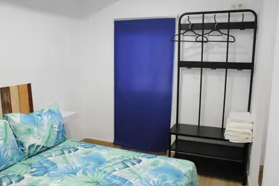 a bedroom with a bed and a blue door at Alojamiento Teja in Arcos de la Frontera