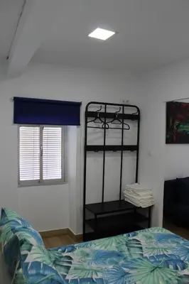 a bedroom with a bunk bed and a window at Alojamiento Teja in Arcos de la Frontera