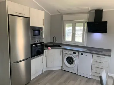 a kitchen with a refrigerator and a washer and dryer at Casa ILEANA in Sanlúcar de Barrameda